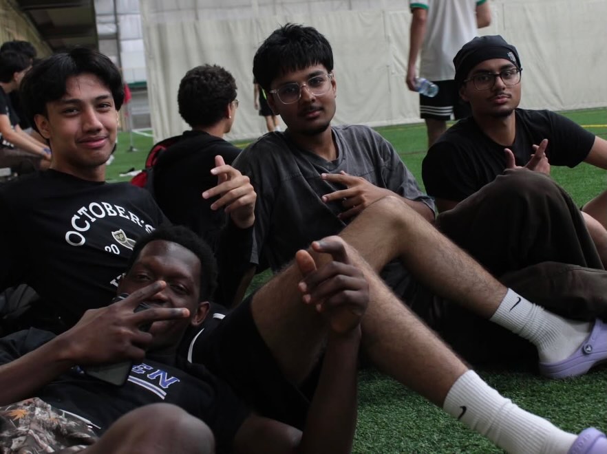 A group of friends sprawled on the turf, laughing between matches